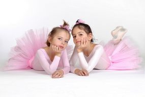 Two young ballet students in pink tutus